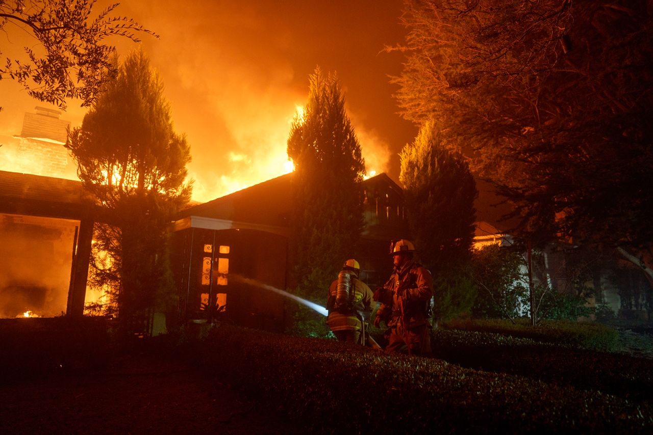 Firefighters battle flames from the Palisades Fire in the Pacific Palisades neighborhood of Los Angeles, California on January 7.