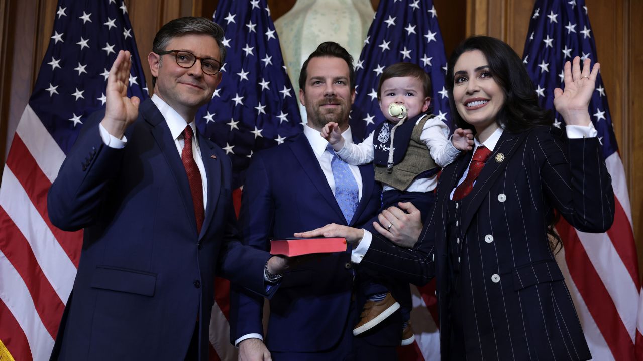 Speaker of the House Mike Johnson, left, participates in a ceremonial swearing-in with Rep. Anna Paulina Luna, right, and her family at the US Capitol on January 3, 2025.