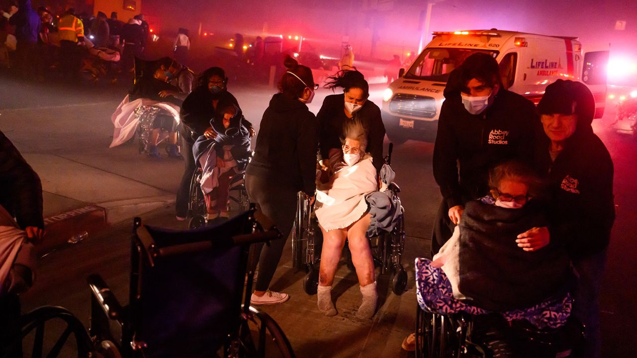 Elderly patients are quickly evacuated into emergency vehicles as embers and flames approach during the Eaton fire in Pasadena, California on January 7, 2025. A ferocious wildfire in a Los Angeles suburb devoured buildings and sparked panicked evacuations January 7, as hurricane-force winds tore through the region. More than 200 acres (80 hectares) was burning in Pacific Palisades, a upscale spot with multi-million dollar homes in the Santa Monica Mountains.
Across town, on the northern edge of Los Angeles, another fire broke out in Eaton Canyon, near Pasadena, quickly consuming 200 acres (81 hectares) later in the night, according to Angeles National Forest officials. (Photo by JOSH EDELSON / AFP) (Photo by JOSH EDELSON/AFP via Getty Images)