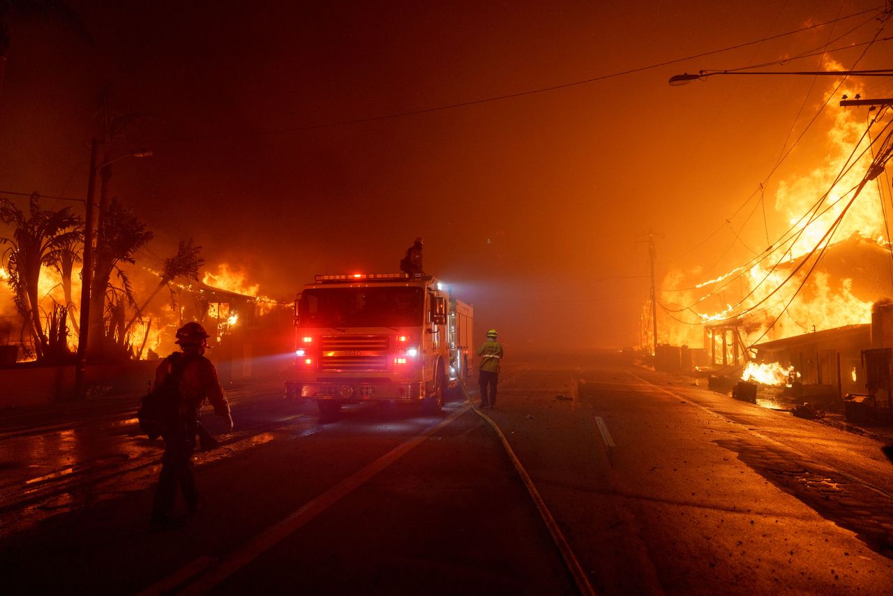 Flames from the Palisades Fire burn homes along Pacific Coast Highway on January 7, in Malibu, California.