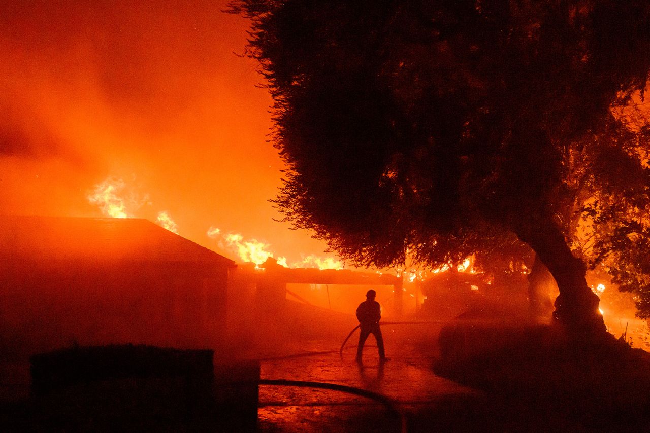 A firefighter works at the scene as dozens of homes continue to burn during the Eaton fire in the Altadena area of Los Angeles County, California on January 7.