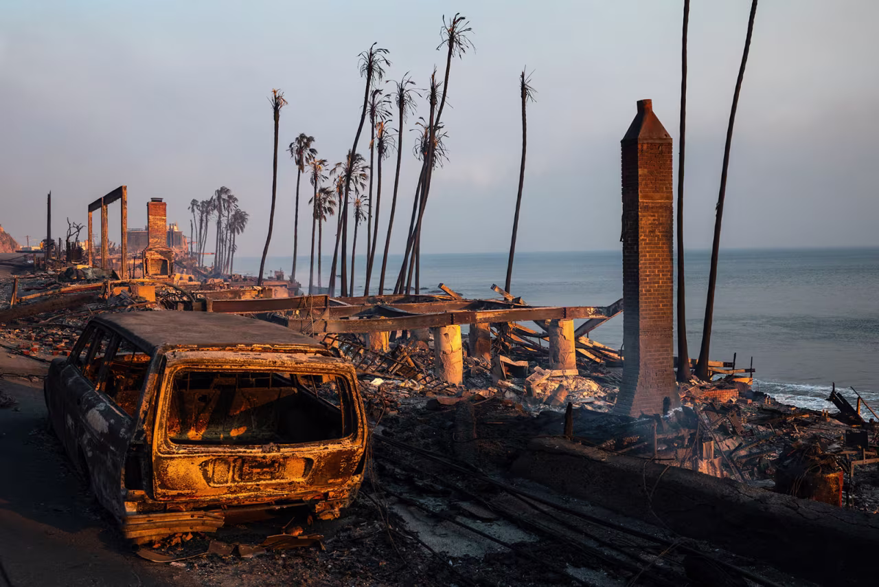 Buildings and cars destroyed by the Palisades fire lay along the Pacific Coast Highway in Malibu, California, on Wednesday,m January 8.