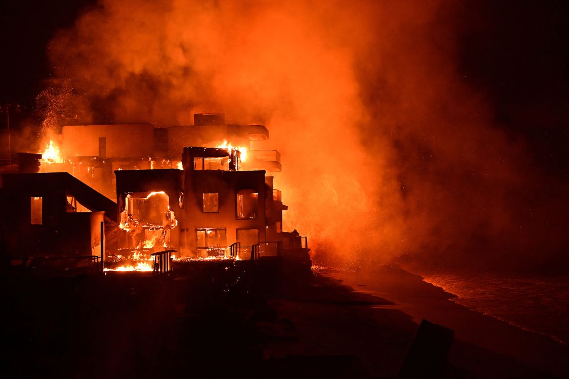 A beach house is engulfed in flames as the Palisades Fire burns along Pacific Coast Highway in Malibu, California on Wednesday.