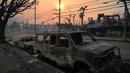 Charred vehicles are seen along a road after the passage of the Palisades Fire in Pacific Palisades, California, on January 8, 2025. At least five people have been killed in wildfires rampaging around Los Angeles, officials said on January 8, with firefighters overwhelmed by the speed and ferocity of multiple blazes. (Photo by AGUSTIN PAULLIER / AFP) (Photo by AGUSTIN PAULLIER/AFP via Getty Images)