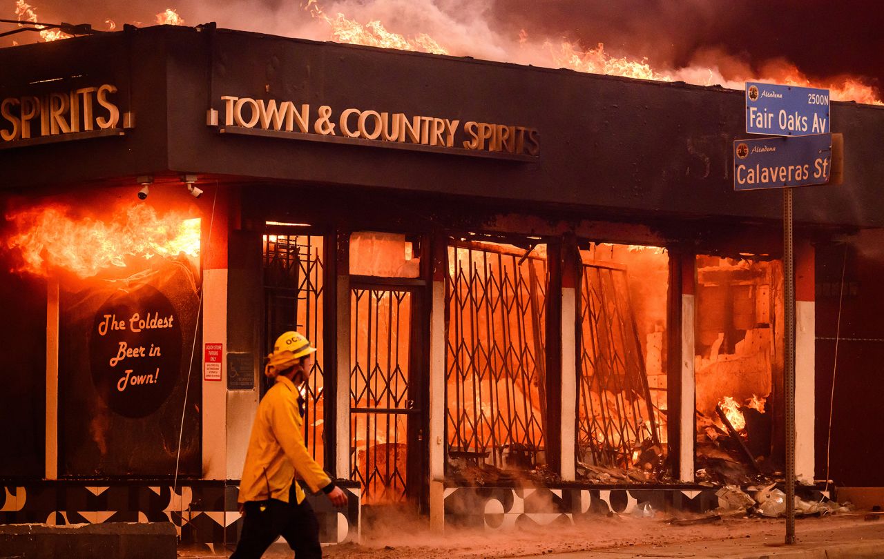 A firefighter walks passed a burning liquor store during the Eaton fire in the Altadena area of Los Angeles County, on January 8.