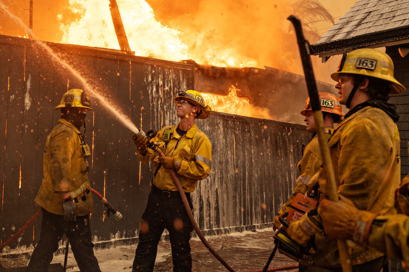 Altadena, CA - January 08: Fire fighters work a fire during Eaton fire on Wednesday, Jan. 8, 2025 in Altadena, CA. (Jason Armond / Los Angeles Times via Getty Images)