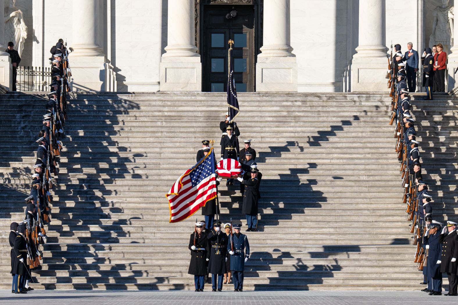 Carter's casket is carried down the steps of the US Capitol.