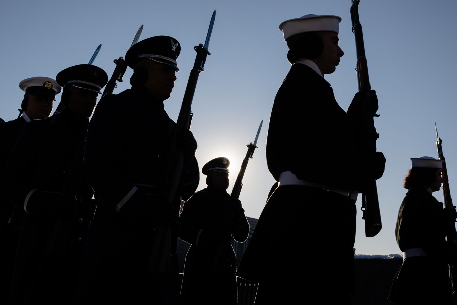 A military honor guard marches toward the steps of the Capitol ahead of the Carter funeral procession.