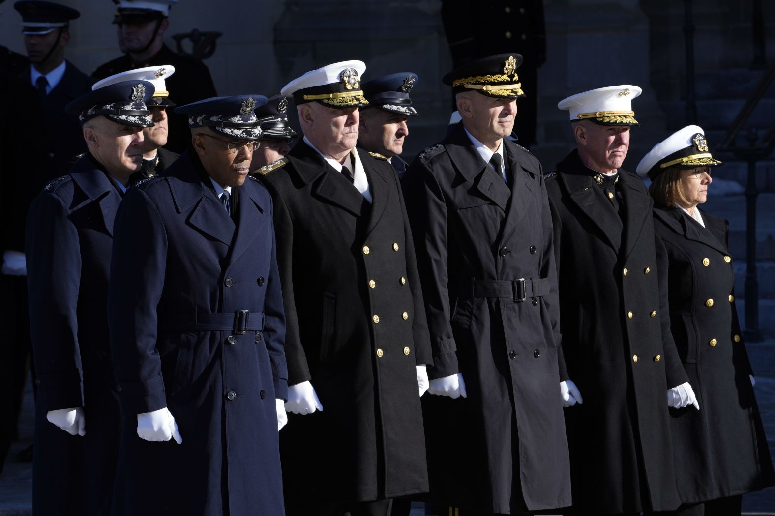 Chairman of the Joint Chiefs of Staff Gen. CQ Brown, left, watches as Carter's casket arrives for the funeral.