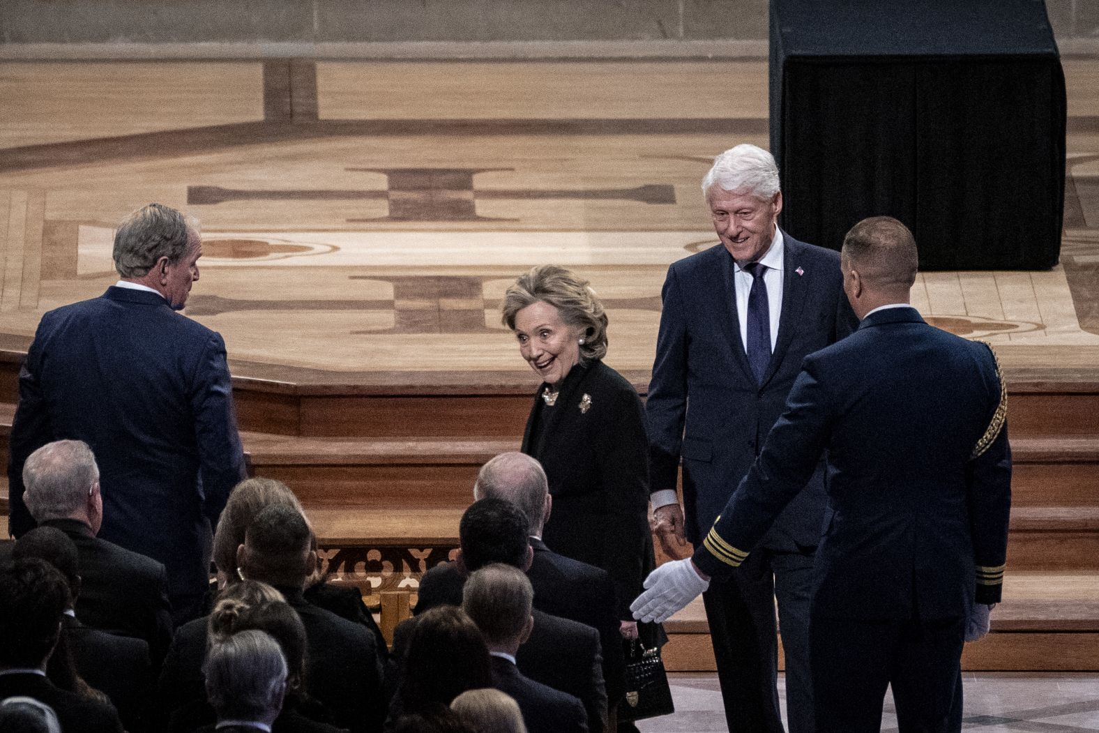 The Clintons arrive for the funeral.