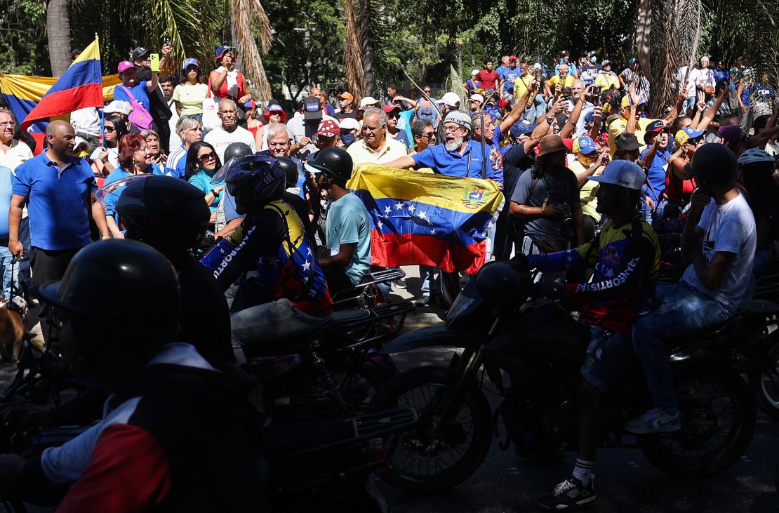 Anti-government demonstrators shout slogans as supporters of Venezuelan President Nicolas Maduro ride past on motorcycles during an opposition protest on the eve of Maduro's inauguration, in Caracas on Thursday.