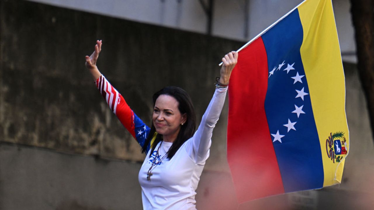 Venezuelan opposition leader Maria Corina Machado waves a national flag during a protest called by the opposition on the eve of the presidential inauguration, in Caracas on January 9, 2025. Venezuela is on tenterhooks facing demonstrations called by both the opposition and government supporters. Machado emerged from hiding to lead protests in Caracas against the swearing-in of Nicolas Maduro for a highly controversial third term as president. (Photo by Juan BARRETO / AFP) (Photo by JUAN BARRETO/AFP via Getty Images)