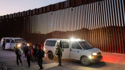 Migrants turn themselves in to US Customs and Border Patrol officers after crossing over a section of border wall into the US on January 5, 2025 in Ruby, Arizona.