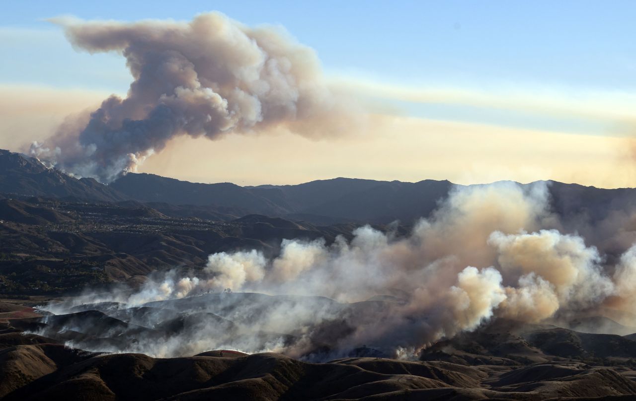 The Kenneth Fire (foreground) approaches homes while the back side of the Palisades Fire (background) continues to burn in Los Angeles County on January 9.