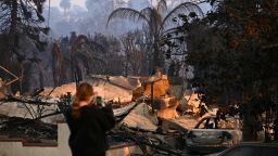 A resident surveys damaged homes during the Palisades Fire in Pacific Palisades, a neighborhood of Los Angeles, California, on January 9.