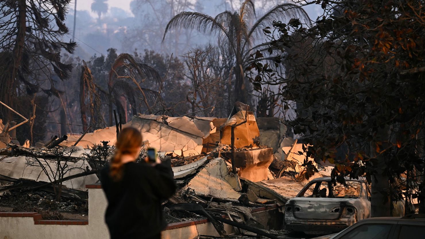 A resident surveys damaged homes during the Palisades Fire in Pacific Palisades, a neighborhood of Los Angeles, California, on January 9.