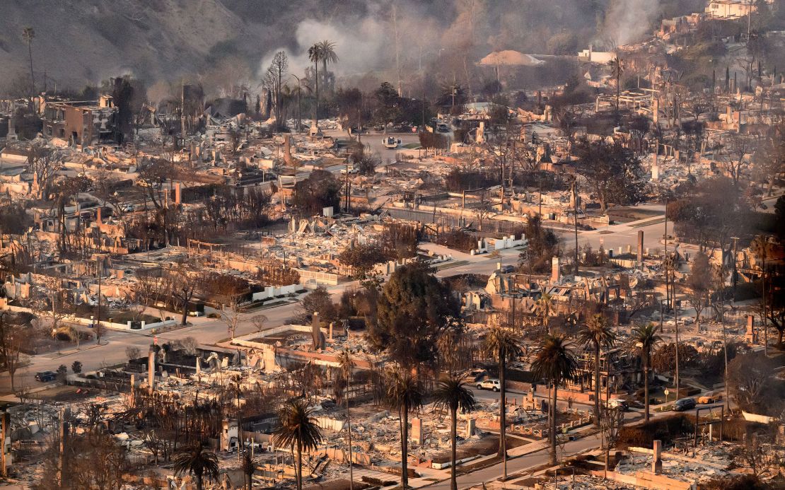 Homes burned from the Palisade fire smolder near the Pacific Palisades neighborhood of Los Angeles on Thursday.