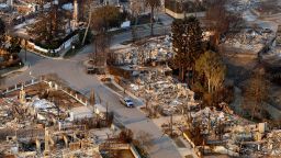 In this aerial view taken from a helicopter, burned homes are seen from above during the Palisades fire in the Pacific Palisades neighborhood of Los Angeles, California on January 9, 2025.