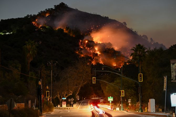 Flames are seen on a mountain near Topanga.