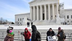 Supporters of Tiktok livestream in front of the US Supreme Court in Washington, DC, on January 10, 2025. The US Supreme Court on Friday will hear TikTok's appeal of a law that would force its Chinese owner to sell the video-sharing platform or shut it down in the United States. (Photo by Mandel NGAN / AFP) (Photo by MANDEL NGAN/AFP via Getty Images)