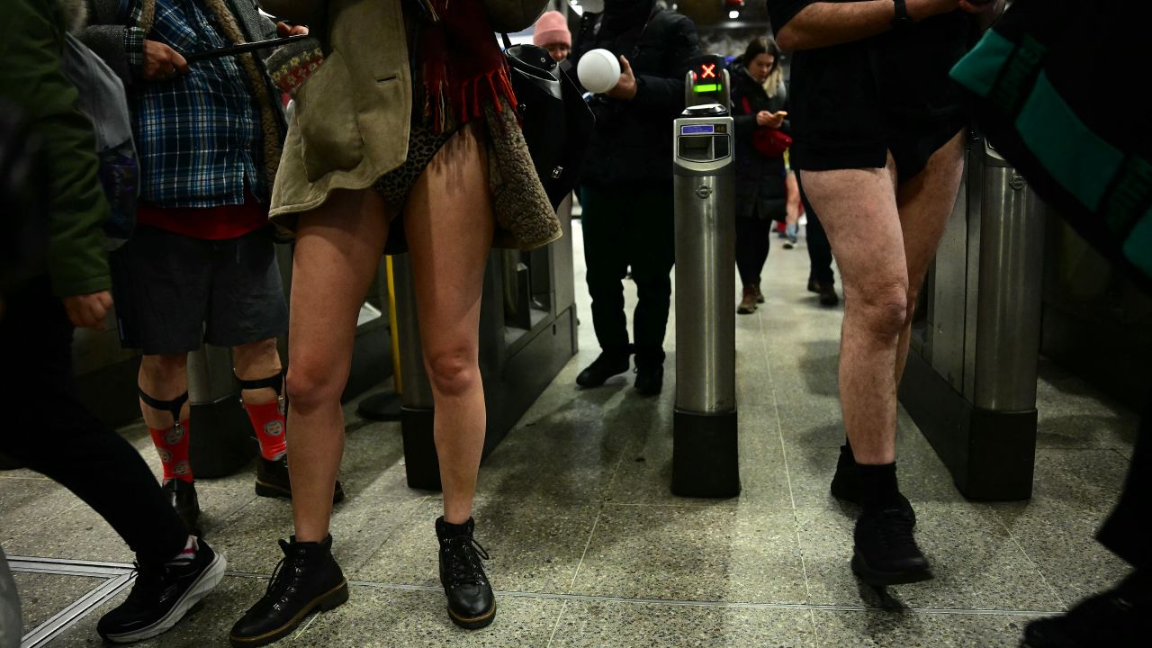 People take part in the annual "No Trousers On The Tube Day" (No Pants Subway Ride), at a station on the London Underground, in London, on January 12, 2025. This day is now marked in over 60 cities around the world. The idea behind "No Pants" is that random passengers board a subway car at separate stops in the middle of winter, without wearing trousers. (Photo by Ben STANSALL / AFP) (Photo by BEN STANSALL/AFP via Getty Images)