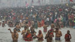 TOPSHOT - Hindu pilgrims take a dip in the sacred waters of Sangam, the confluence of Ganges, Yamuna and mythical Saraswati rivers during the Maha Kumbh Mela festival in Prayagraj on January 13, 2025. Vast crowds of Hindu pilgrims in India began bathing in sacred waters on January 13, as the Kumbh Mela festival opened, with organisers expecting 400 million people -- the largest gathering of humanity. (Photo by Niharika KULKARNI / AFP) (Photo by NIHARIKA KULKARNI/AFP via Getty Images)