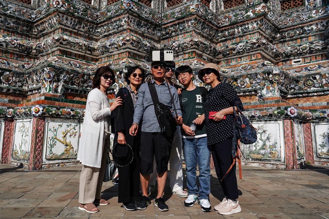 Chinese tourists take photos at Wat Arun in Bangkok, Thailand, on January 13, 2025.