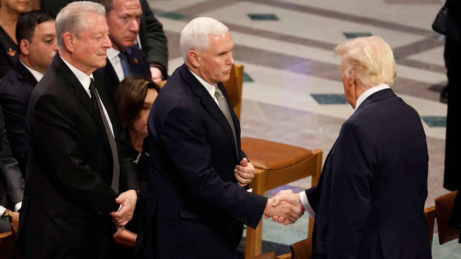 Trump and Pence shake hands before the funeral.