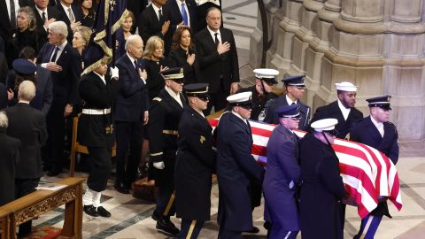 The flag-draped casket bearing the remains of former U.S. President Jimmy Carter is carried into the Washington National Cathedral for his state funeral on January 09 in Washington as President Joe Biden together with former US presidents look oin.  DC.
