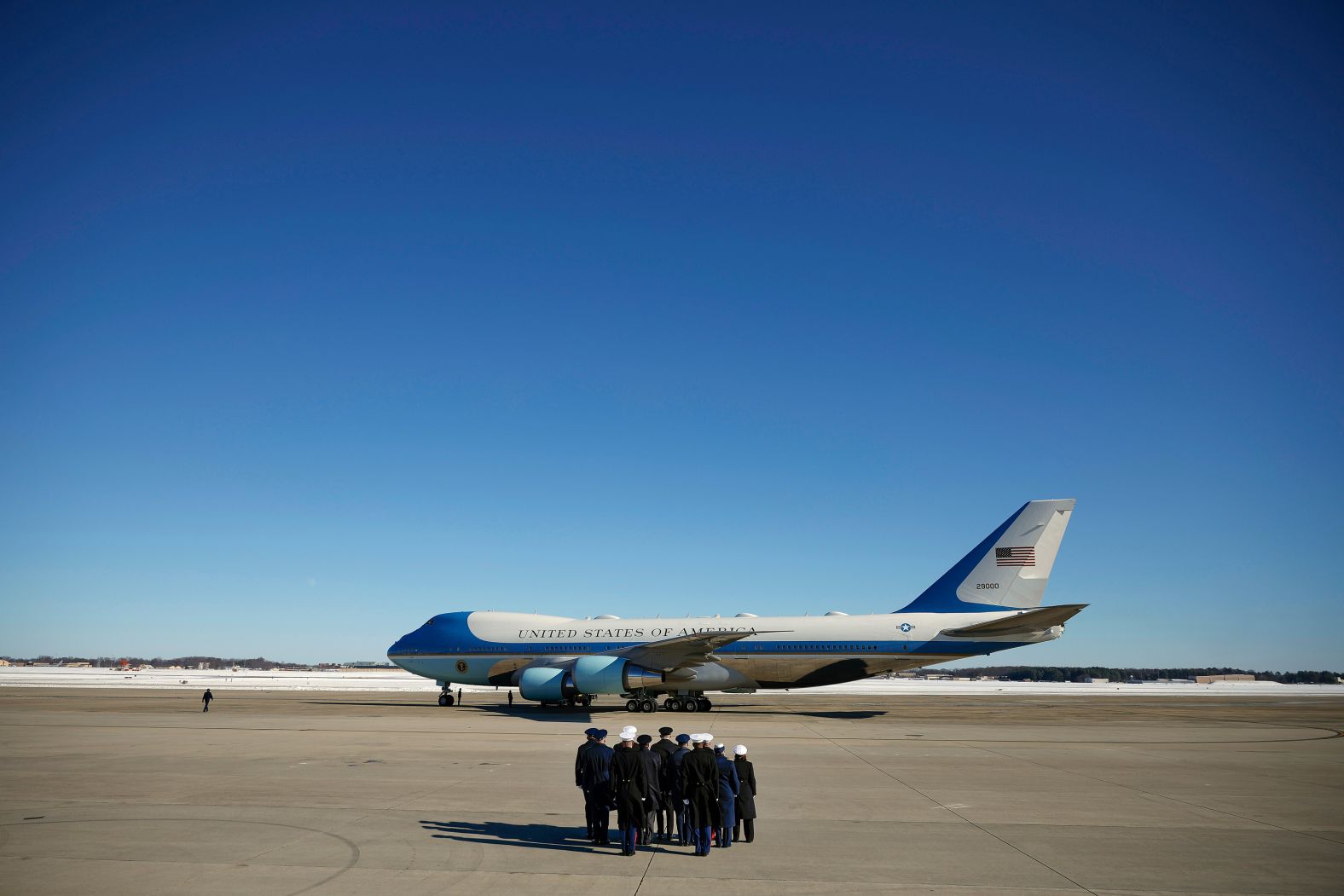 A military honor guard stands at attention as they prepare the plane, Special Air Mission 39, to depart Joint Base Andrews, Maryland. Carter's casket will be flown to Plains, Georgia, for a private family service and burial.