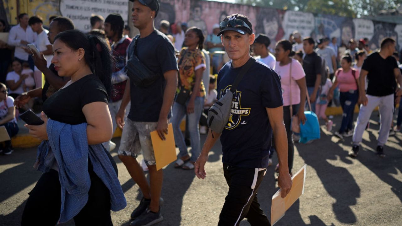 Migrants wait outside the regional office of the National Migration Institute to await their safe conduct to transit through Mexican territory on their way to the United States, in Tapachula, Chiapas state, Mexico on January 13, 2025. Although US President Joe Biden's istration said last week that nearly one million immigrants from El Salvador, Sudan, Ukraine and Venezuela will be allowed to legally remain in the United States for another 18 months, President-elect Donald Trump has pledged to carry out a mass deportation of migrants after taking office on January 20. (Photo by ALFREDO ESTRELLA / AFP) (Photo by ALFREDO ESTRELLA/AFP via Getty Images)