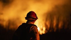 A firefighter monitors the spread of the Auto Fire in Oxnard, North West of Los Angeles, California, on January 13, 2025. US officials warned "dangerous and strong" winds were set to push deadly wildfires further through Los Angeles residential areas January 12 as firefighters struggled to make progress against the flames. At least 24 people have been confirmed dead from blazes that have ripped through the city, reducing whole neighborhoods to ashes and leaving thousands without homes. (Photo by ETIENNE LAURENT / AFP) (Photo by ETIENNE LAURENT/AFP via Getty Images)