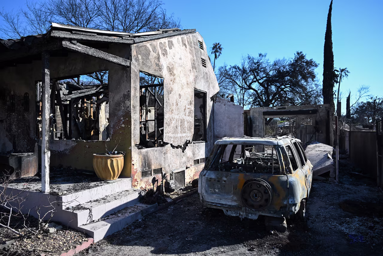 A view of a burned house and a car in Altadena, Los Angeles County, California, on January 13.