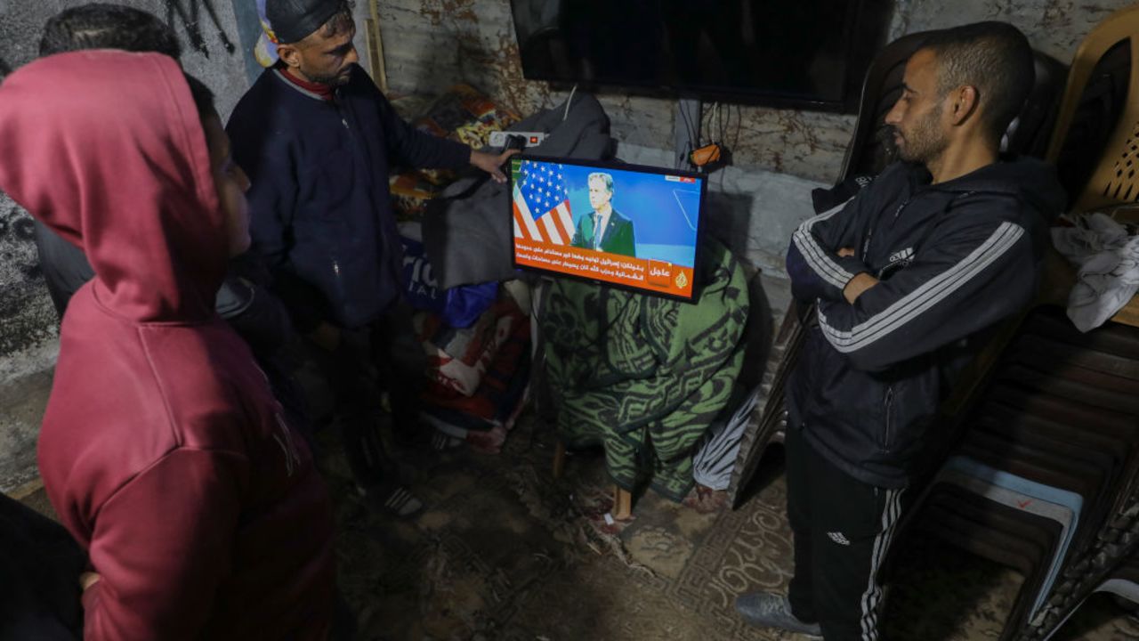 Residents of the Bureij camp watch news updates together on January 14, 2025. Displaced residents follow developments as they await signs of peace and a ceasefire. (Photo by Moiz Salhi / Middle East Images / Middle East Images via AFP) (Photo by MOIZ SALHI/Middle East Images/AFP via Getty Images)