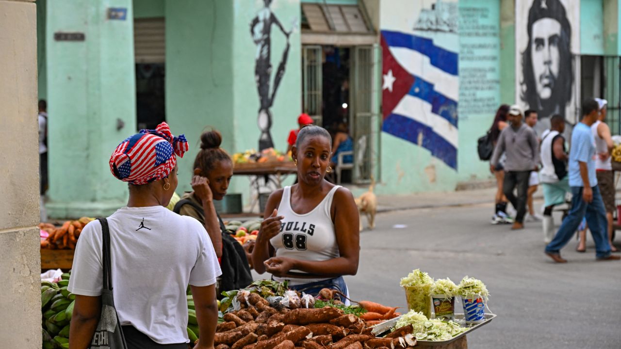 Cubans buy food in a street of Havana, on January 14, 2025. President Joe Biden is removing the US designation of Cuba as a state sponsor of terrorism, the White House said, in a deal that will see imprisoned protesters released in the communist country. Cuba has been dealing with over six decades of US sanctions, which the Cuban government blames for the island nation's worst economic crisis, with shortages of fuel, food, medicines and electricity. (Photo by YAMIL LAGE / AFP) (Photo by YAMIL LAGE/AFP via Getty Images)