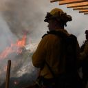 Firefighters monitor the Palisades Fire as it burns through the area on January 10, 2025 in Los Angeles, California. The Palisades fire had grown to over 22,000 acres and has destroyed thousands of homes. The fire is currently 11 percent contained.