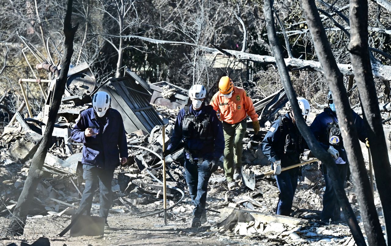 Search and rescue workers look through the rubble of homes demolished by the Eaton Fire in Altadena, California on Wednesday.