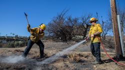 LOS ANGELES, CALIFORNIA - JANUARY 15: Firefighters extinguish a hotspot from the Palisades Fire in the Pacific Palisades neighborhood on January 15, 2025 in Los Angeles, California. Multiple wildfires fueled by intense Santa Ana Winds continue to burn across Los Angeles County, with some containment achieved. At least 25 people have died, more than 12,000 structures have been destroyed or damaged, and 40,000 acres burned. More than 88,000 people remain under evacuation orders as high winds are forecast. (Photo by Apu Gomes/Getty Images)