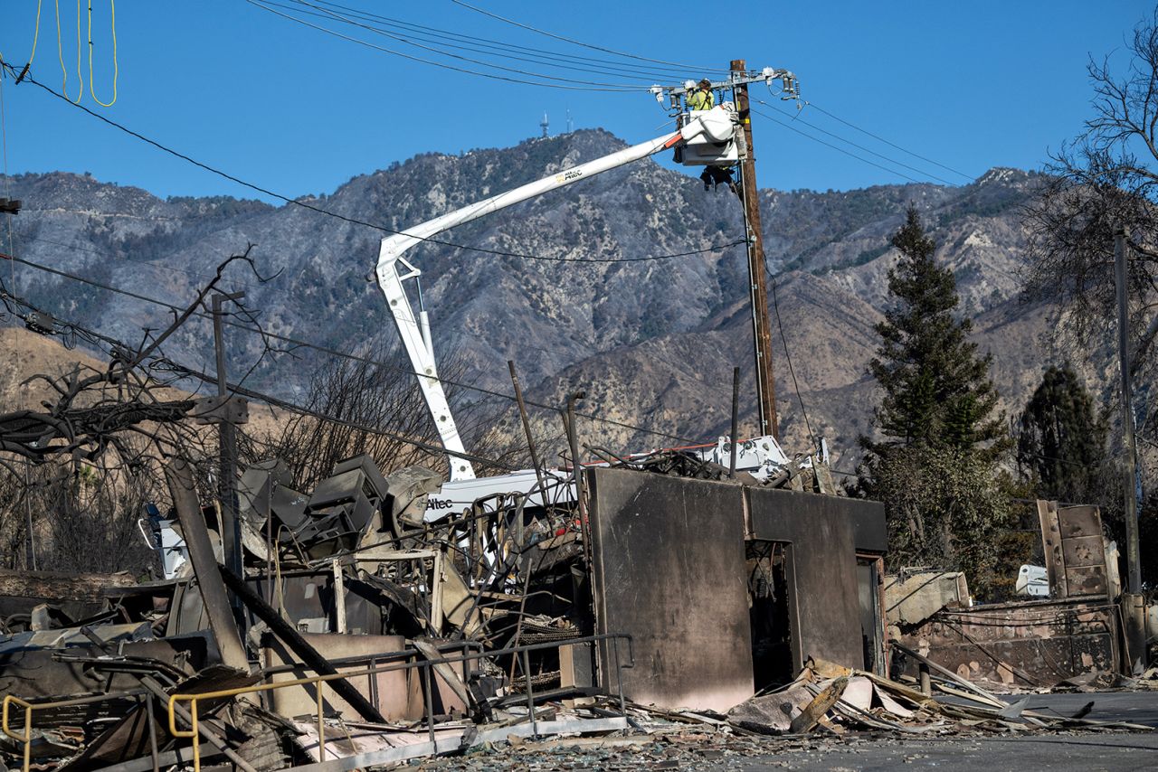 Utilities worker repair lines on Mendocino Ave in the Eaton Fire damaged area on Lake Ave in Altadena, on Tuesday.