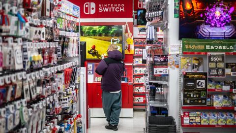 A man walks past shelves in the gaming section of Nintendo Switch products at a shop in Tokyo on January 16, 2025.