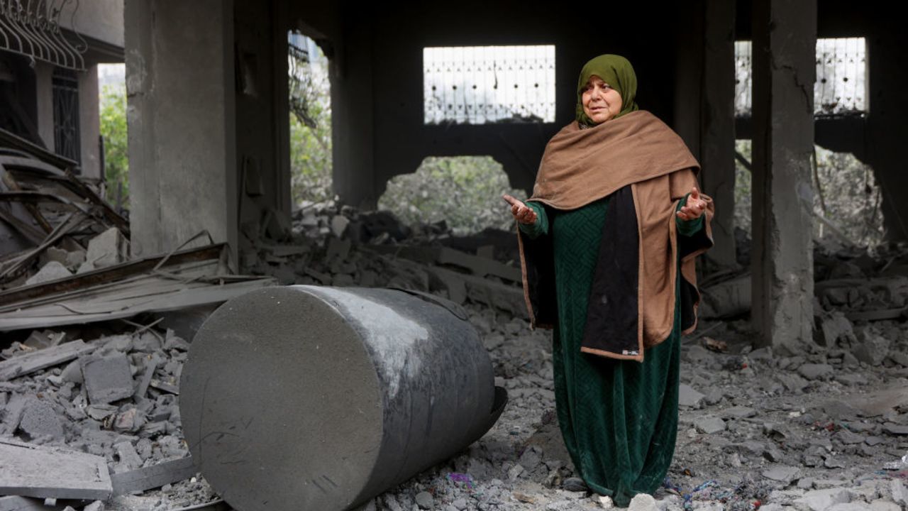 A Muslim woman prays in the rubble of a building hit in Israeli strikes the previous night in Jabalia in the northern Gaza Strip, on January 16, 2025, following a truce announcement amid the war between Israel and the Palestinian Hamas movement. (Photo by Omar AL-QATTAA / AFP) (Photo by OMAR AL-QATTAA/AFP via Getty Images)