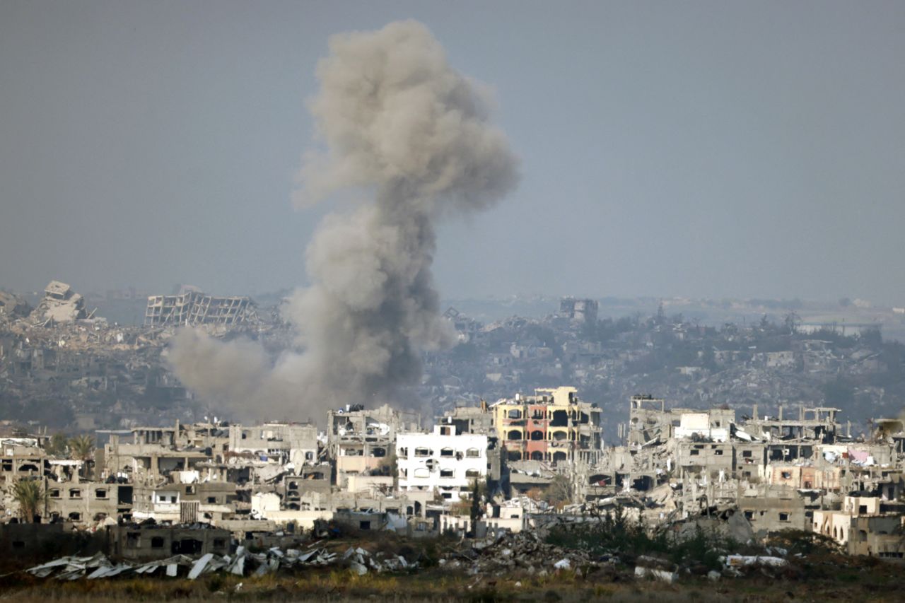 This picture taken from the Israeli side of the border with the Gaza Strip shows smoke plumes rising from explosions above destroyed buildings in the northern Gaza Strip on January 16, 2025, following the announcement of a truce amid the ongoing war between Israel and Hamas. (Photo by Menahem KAHANA / AFP) (Photo by MENAHEM KAHANA/AFP via Getty Images)