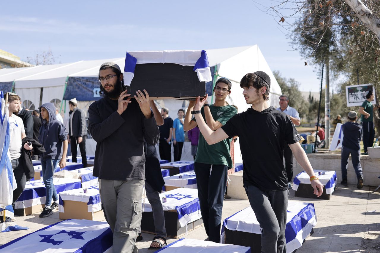 Protesters hold up a mock coffin draped in the national flag of Israel outside the Supreme Court in Jerusalem on January 16.