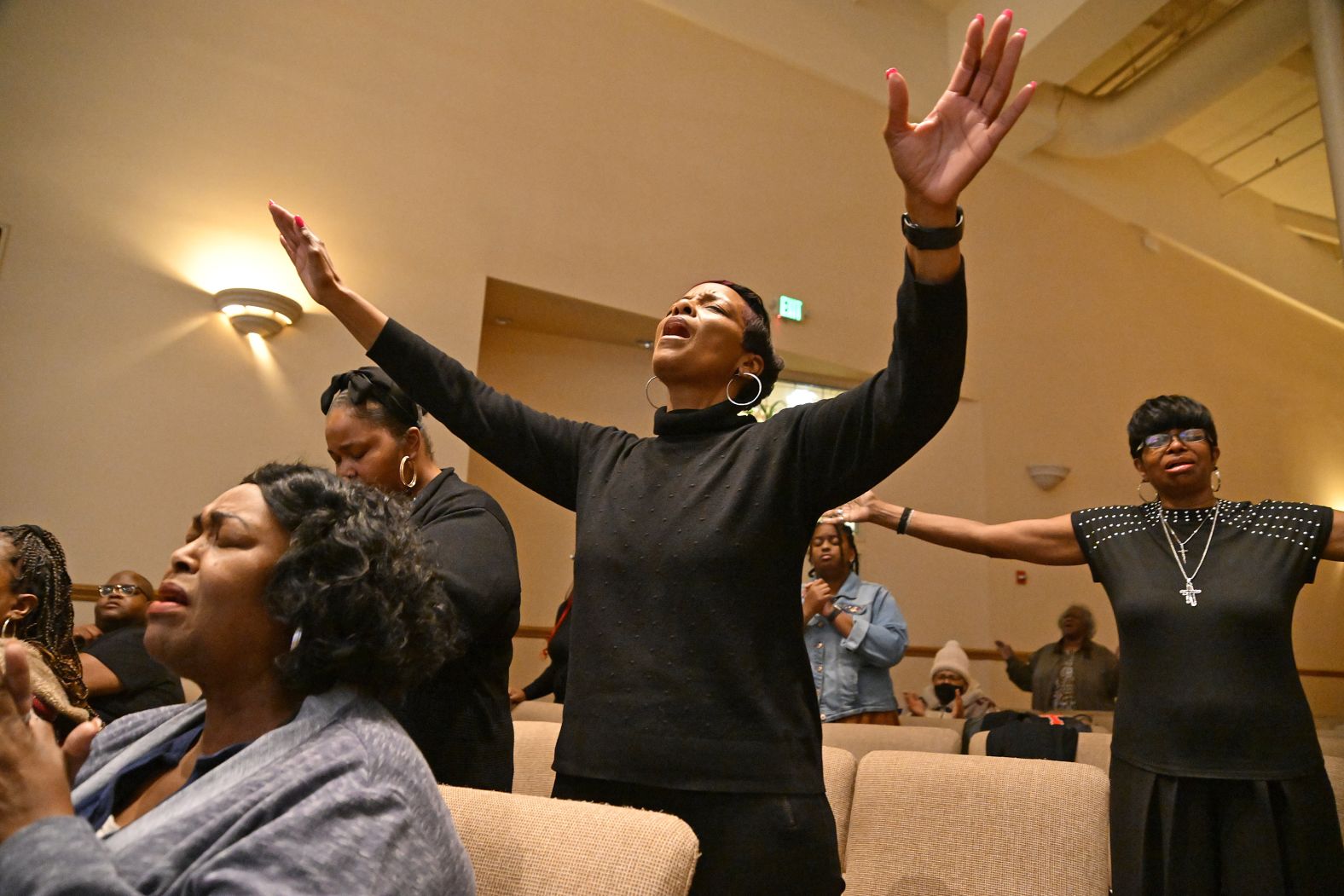 People sing at the Love and Unity Christian Fellowship church in Compton. A worship night of healing and restoration was held for families affected by the fires.