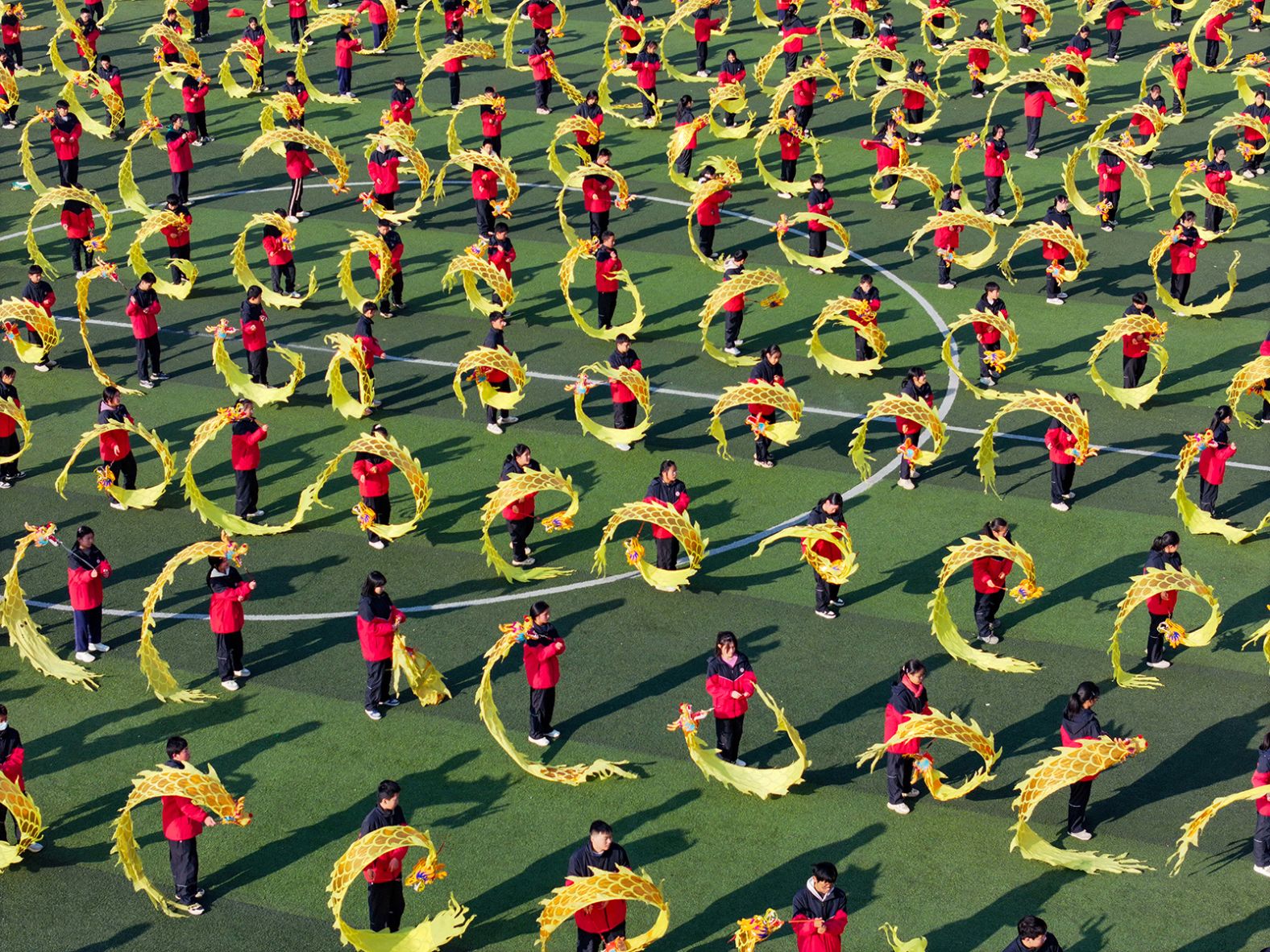 Students perform a colorful ribbon dragon dance on the playground of Qingyunpu Campus of Nanchang Middle School in East China's Jiangxi province, on January 17.