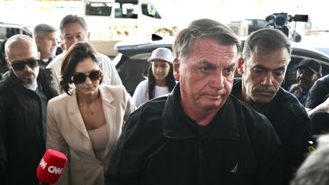 Former Brazilian President Jair Bolsonaro (2-R) accompanies his wife, Michelle Bolsonaro (2-L), at Brasilia airport on January 18, 2025, to board a plane bound for the US to represent him in President-elect Donald Trump's inauguration after a Brazilian judge denied his request to travel. A Brazilian judge on Friday rejected an appeal by former president Jair Bolsonaro to have his port returned to him so he could attend the inauguration of his hero, US President-elect Donald Trump. The right-wing former leader had his port seized in February 2024 as part of an investigation into his role in masterminding an alleged coup attempt to remain in power after losing elections in 2022. (Photo by EVARISTO SA / AFP) (Photo by EVARISTO SA/AFP via Getty Images)