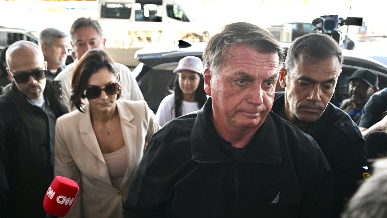 Former Brazilian President Jair Bolsonaro (2-R) accompanies his wife, Michelle Bolsonaro (2-L), at Brasilia airport on January 18, 2025, to board a plane bound for the US to represent him in President-elect Donald Trump's inauguration after a Brazilian judge denied his request to travel. A Brazilian judge on Friday rejected an appeal by former president Jair Bolsonaro to have his port returned to him so he could attend the inauguration of his hero, US President-elect Donald Trump. The right-wing former leader had his port seized in February 2024 as part of an investigation into his role in masterminding an alleged coup attempt to remain in power after losing elections in 2022. (Photo by EVARISTO SA / AFP) (Photo by EVARISTO SA/AFP via Getty Images)