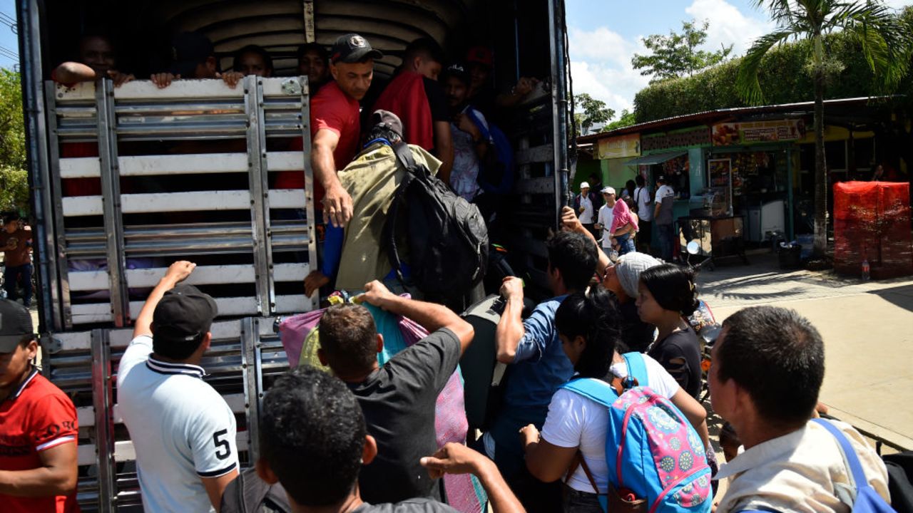 Displaced people from recent clashes between armed groups board the back of a truck in the municipality of Tibu, Norte de Santander Department, Colombia, on January 18, 2025. At least 39 people have been killed in violence involving leftwing guerillas near Colombia's restive border with Venezuela, authorities said Friday, prompting the government to suspend high-stakes peace talks with the group. (Photo by Schneyder Mendoza / AFP) (Photo by SCHNEYDER MENDOZA/AFP via Getty Images)