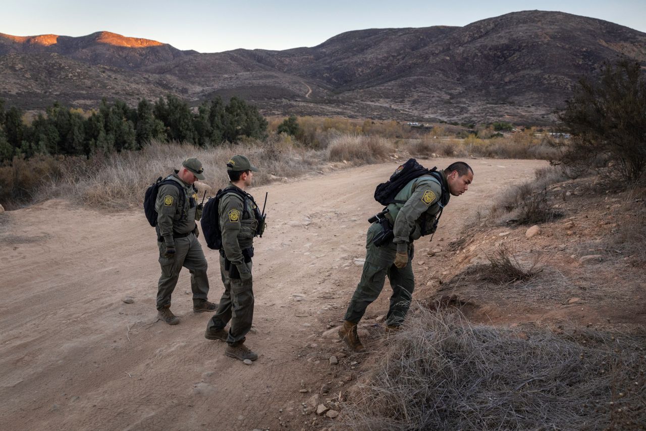 US Border Patrol agents track a group of immigrants who had crossed the border from Mexico near Jamul, California on Wednesday.