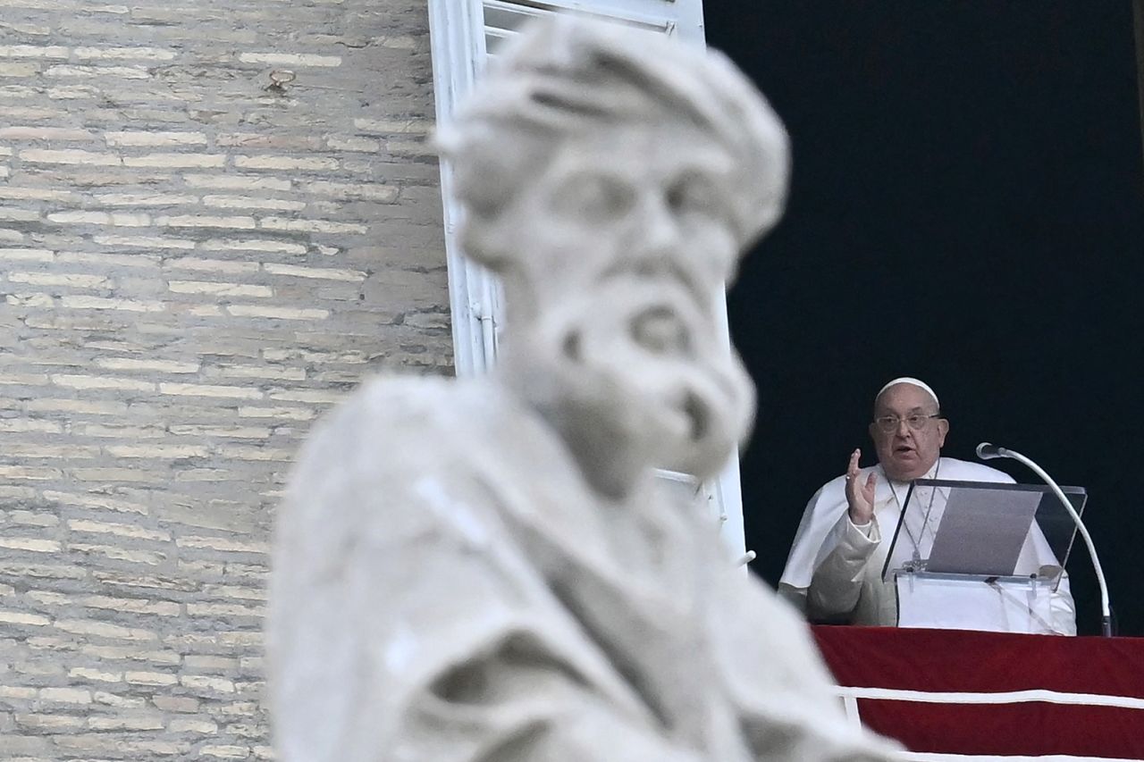 Pope Francis blesses the crowd from the window of the apostolic palace overlooking St. Peter's square in The Vatican on Sunday.